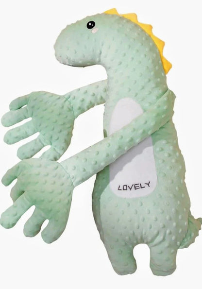 A light green textured plush dinosaur toy with a yellow spiky back, black eyes, and a white belly patch that reads 'LOVELY' in black text, shown against a plain white background.